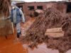 A resident walks through toxic sludge in the flooded village of Devecser