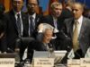 Japan's Environment Minister Matsumoto touches his head at the plenary session of the 10th Conference of the Parties to the Convention on Biological Diversity in Japan